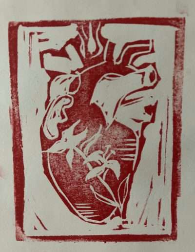 Block print of a anatomical heart with lilies across it.